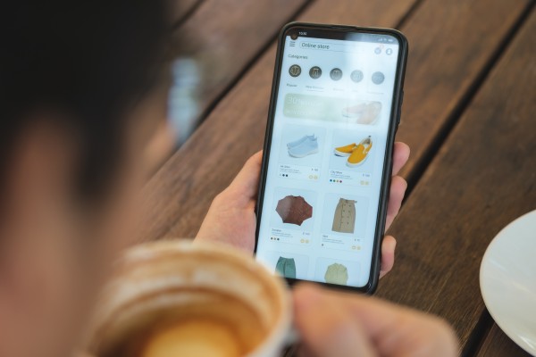 overhead view of someone shopping for shoes on their phone